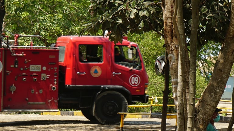 A firetruck entering the dump site after re-filling its tank.