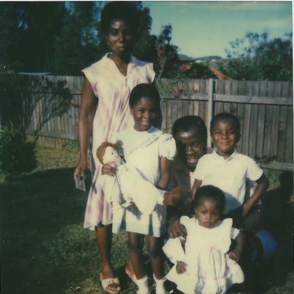 Gbogbo (holding a doll) with her mother, father and siblings, in 1985. 