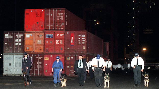 In an iconic image of the dispute, photographer Dean Sewell captured security guards with dogs turfing workers out of Patrick's Sydney port botany wharf.