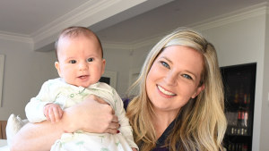 Anna Baker, pictured with four-month-old Luka at a client’s home, helps CEOs get better sleep by sleep-training their babies. 