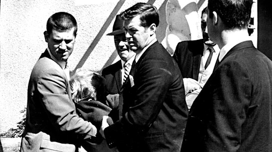 A man being carried by police from the scene of the siege on September 9, 1969.