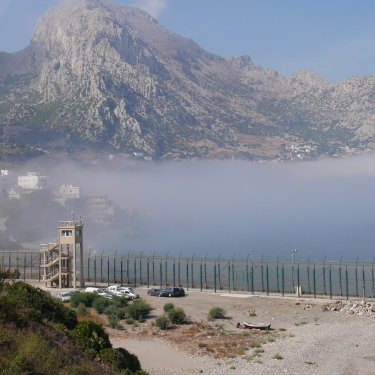 Looking west from Ceuta across the border fence to the Moroccan mountain Jebel Musa.