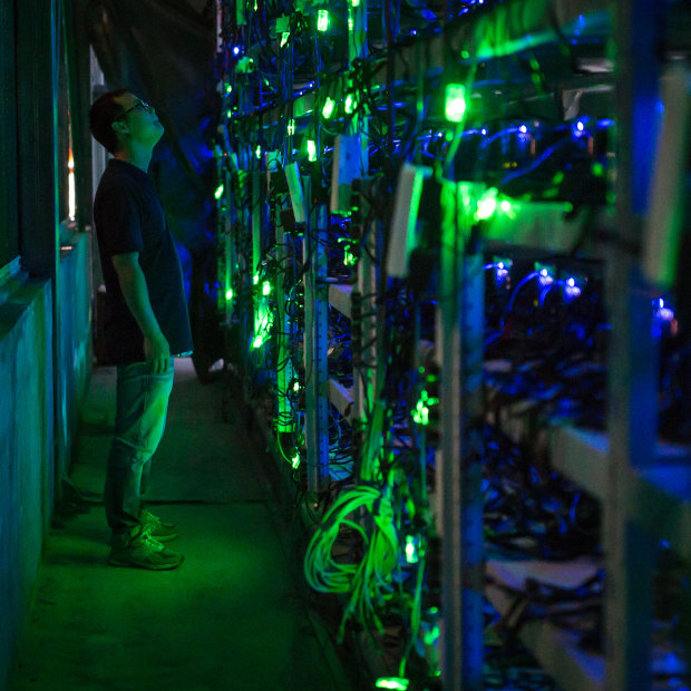 A manager checks equipment in a bitcoin mine in Sichuan, China.
