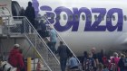 Passengers board a full Bonza flight from Melbourne to Port Macquarie on Thursday.