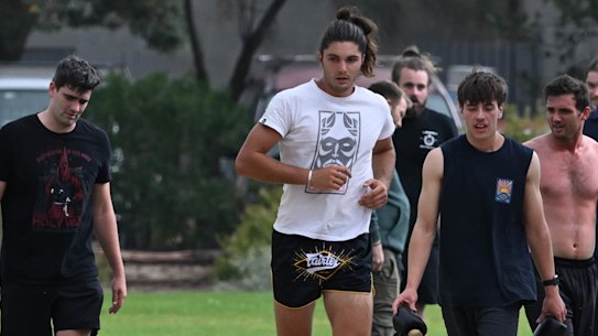 Jacob Hersant, in black and red T-shirt, and others conduct fitness drills in Elwood