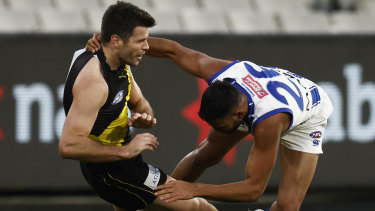 Trent Cotchin is tackled high by Tarryn Thomas