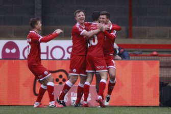 Crawley Town players surround Jordan Tunnicliffe after the side's third goal against Leeds United.