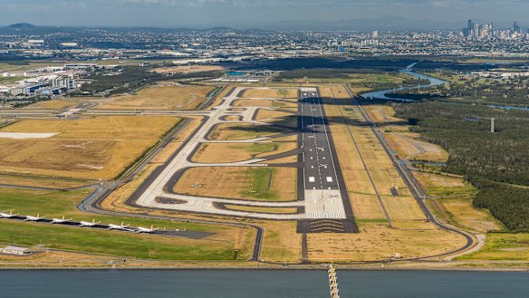 The new stretch of tarmac will be Brisbane Airport's third runway, but an existing one (bottom left) has been clogged by parked Virgin Australia aircraft in recent months.