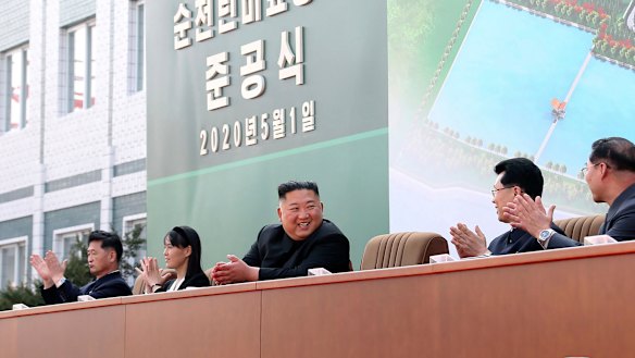 North Korean leader Kim Jong-un, centre, claps during a ceremony at a fertiliser factory in South Pyongan, near Pyongyang, North Korea.