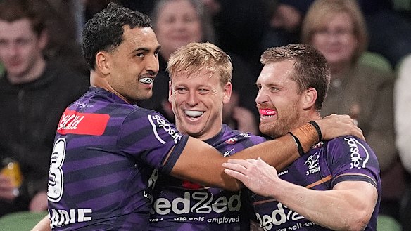 Tyran Wishart celebrates with Xavier Coates and Cameron Munster after scoring a try in round eight against the Rabbitohs.