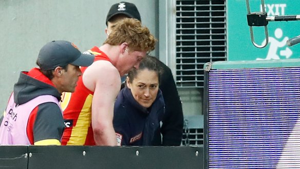 Matt Rowell with the club's doctor.