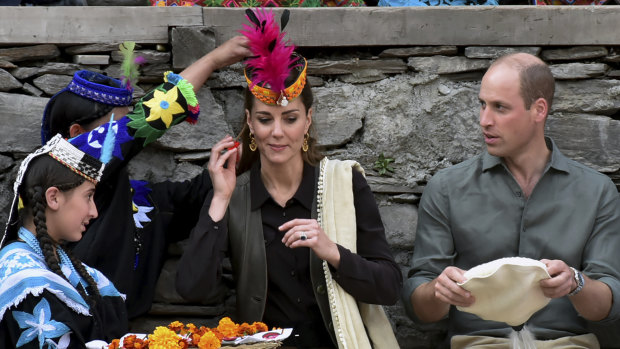 Members of Kalash community greet the royals with traditional caps during their visit to Pakistan's northern Chitral district.