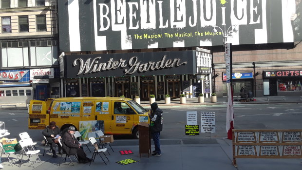 Preacher Brian Kelly, rights, carries on in locked down New York City.