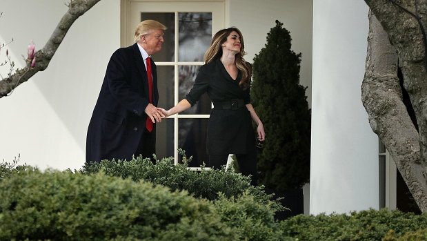 President Donald Trump shakes hands with Communications Director Hope Hicks on her last day at the White House in March, 2018. She has since returned to work on his re-election campaign.