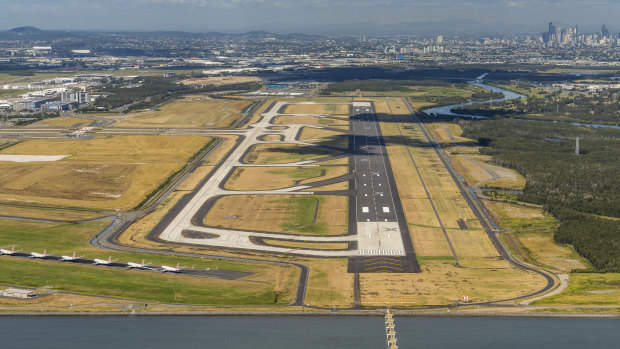The new stretch of tarmac will be Brisbane Airport's third runway, but an existing one (bottom left) has been clogged by parked Virgin Australia aircraft in recent months.