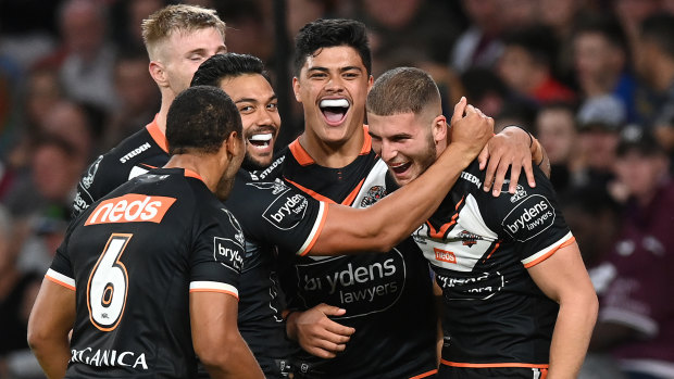 Adam Doueihi and the Tigers celebrate a try against the Knights in May.