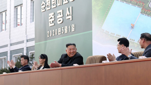 North Korean leader Kim Jong-un, centre, claps during a ceremony at a fertiliser factory in South Pyongan, near Pyongyang, North Korea.