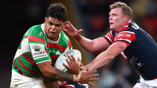 Latrell Mitchell runs into the Roosters defence.