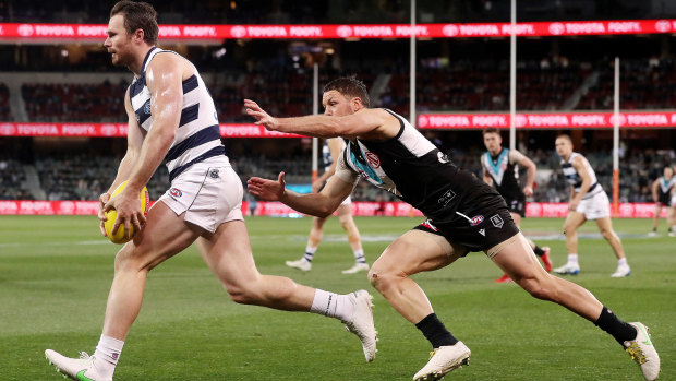 A lunging Travis Boak in pursuit of Cat Patrick Dangerfield in the qualifying final between Port Adelaide and Geelong.