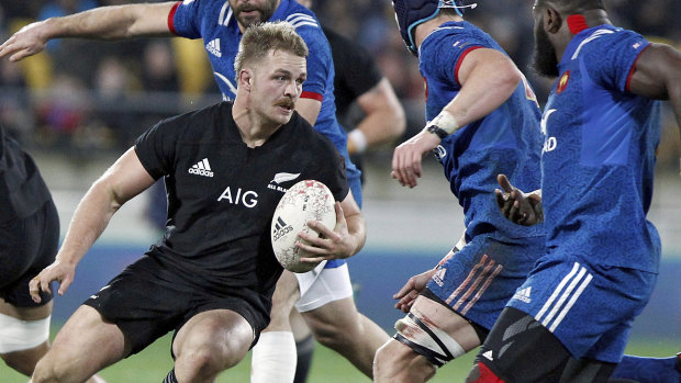 New Zealand's Sam Cane looks for a way past France.