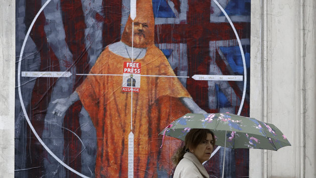 A pedestrian passes street art depicting Julian Assange near Westminster Magistrates' Court in London where he appeared. 