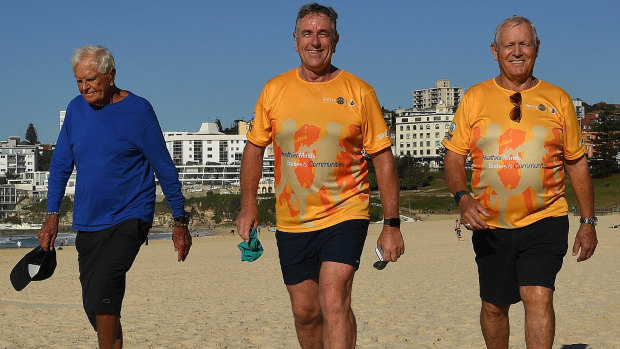 Another year, another run: Charles Rochester, left, Chris Edwards, centre, and Ted Thompson walk along  Bondi Beach.