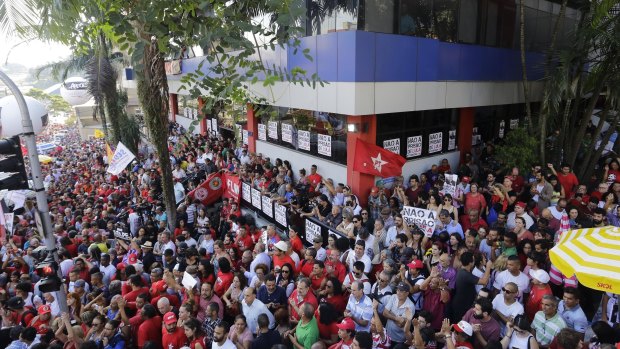 Supporters of Brazil's former President Luiz Inacio Lula da Silva gather outside the metal workers union headquarters where da Silva is hunkered down, in Sao Bernardo do Campo, Brazil.