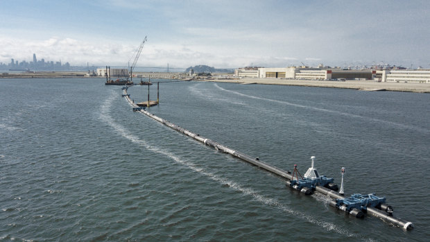 The Ocean Cleanup, a long floating boom that will be used to corral plastic litter in the Pacific Ocean is assembled in Alameda, California.