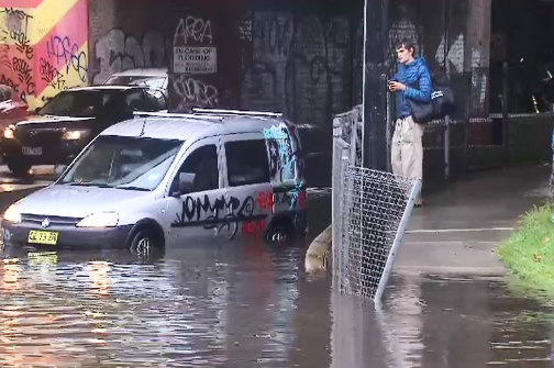A driver has had to escape their car in Dudley Street on Friday morning after becoming caught in storm water .