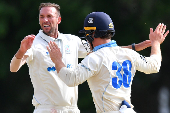 NSW paceman Trent Copeland (left) celebrates with Daniel Solway after taking a wicket on Thursday.