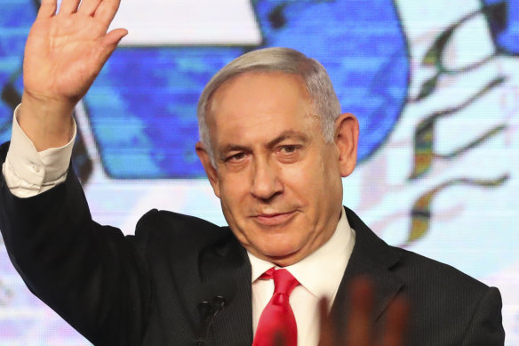 In this Wednesday, March 24, 2021, file photo, Israeli Prime Minister Benjamin Netanyahu waves to his supporters after the first exit poll results for the Israeli parliamentary elections.