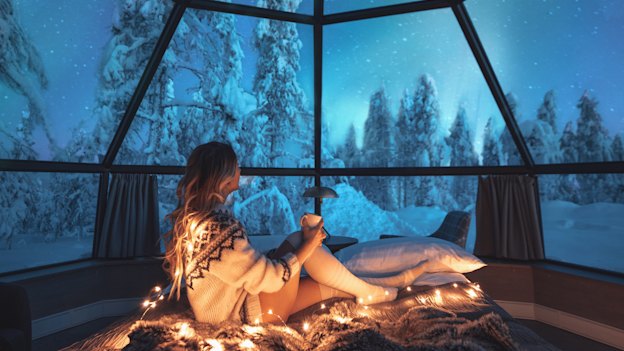 Watching the northern lights in Lapland from a glass igloo.