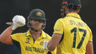 David Warner congratulates teammate Marcus Stoinis for hitting a six.