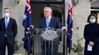 Prime Minister Scott Morrison, flanked by NSW Treasurer Dominic Perrottet and Premier Gladys Berejiklian.