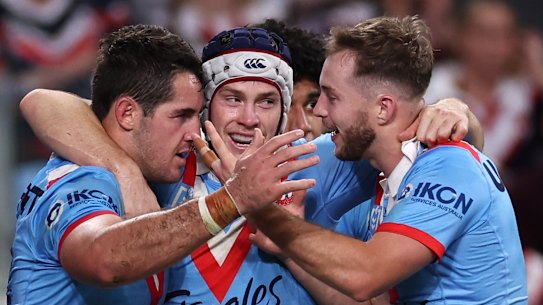 Nat Butcher, Luke Keary and Sam Walker celebrate a try.