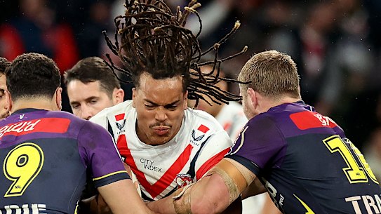 Roosters winger Dominic Young braces for contact as the Storm make a two-man tackle.