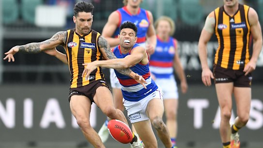 Chad Wingard is tackled by Jason Johannisen.