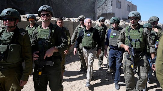 Prime Minister Benjamin Netanyahu (centre) walks with Israeli forces during a surprise visit to Rafah, Gaza, on Thursday.