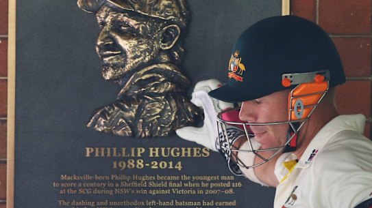 David Warner touches a tribute to Phillip Hughes at the SCG in 2015.