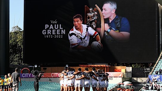 Cowboys players observe a minute of silence in memory of former coach Paul Green at the SCG.