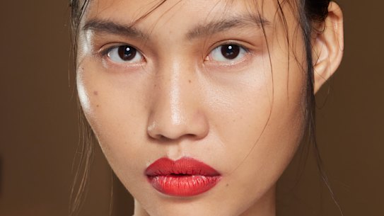 Make-up artist Diane Kendal used a punchy red lip with a backdrop of fresh dewy skin and a nude eye for this look.
