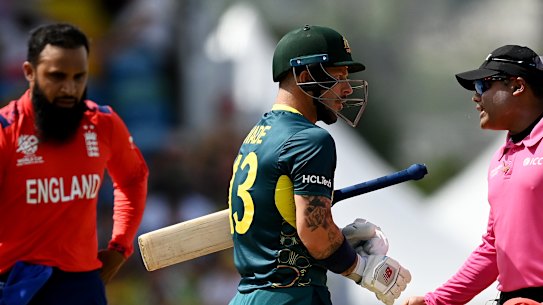 Matthew Wade speaks to umpire Nitin Menon after a delivery he felt should have been a dead ball.