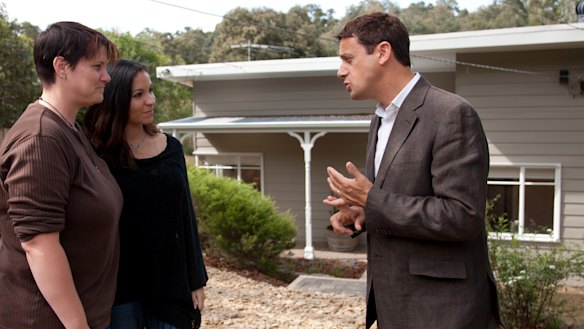 Winter, right, speaks with a couple desperate to sell their newly renovated home.