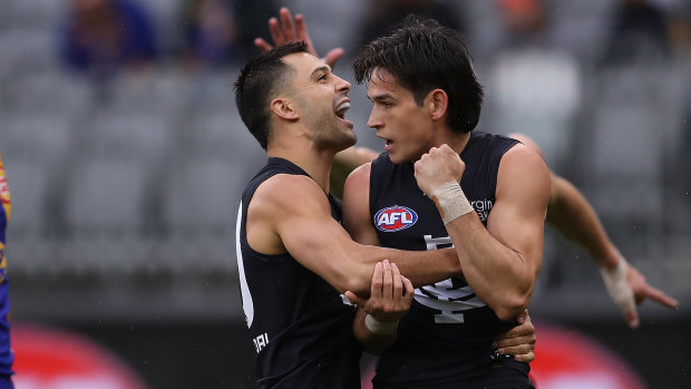 Back in the attack: Carlton's Michael Gibbons (left) congratulates Zac Fisher after a goal.