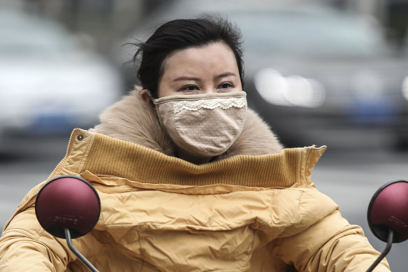 A woman wears a mask in Wuhan, where the virus is believed to have originated.