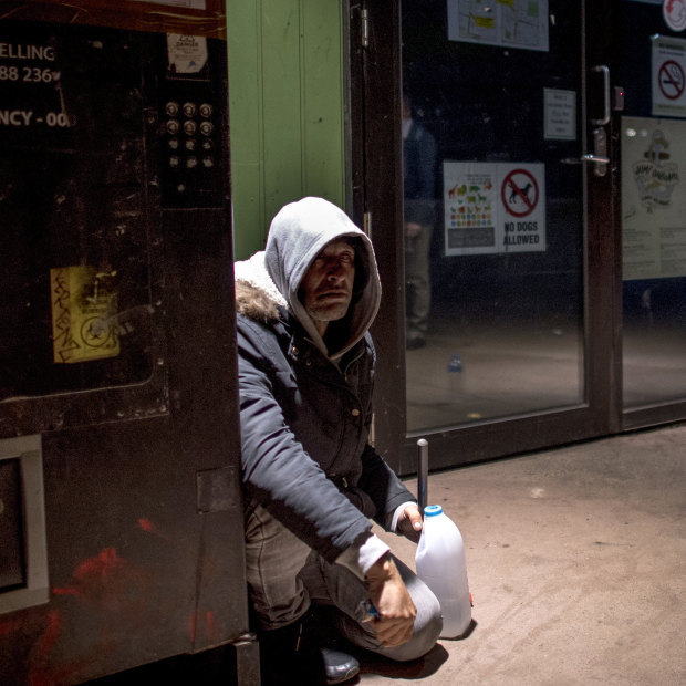 Steve sits next to the needle vending machine outside the safe injecting room.