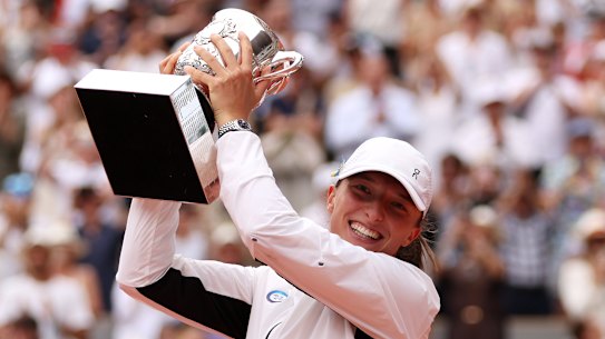 Iga Swiatek of Poland celebrates with her trophy after victory against Karolina Muchova of Czech Republic.