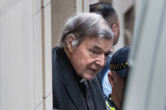 George Pell is led into the Victorian Supreme Court. 