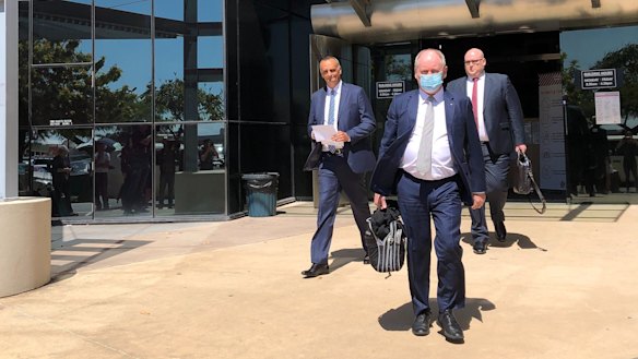 John Osborne from Ardent Leisure (left) and Bruce Hodgkinson, QC, wearing a mask, leave Southport Magistrates Court.