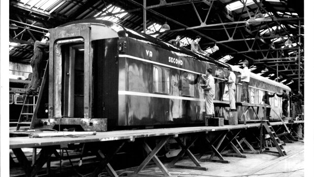 Painters at Newport Workshops in 1973 put finishing touches on the Victorian Railways new luxury twinette carriage which will be operated with the Spirit of Progress train.